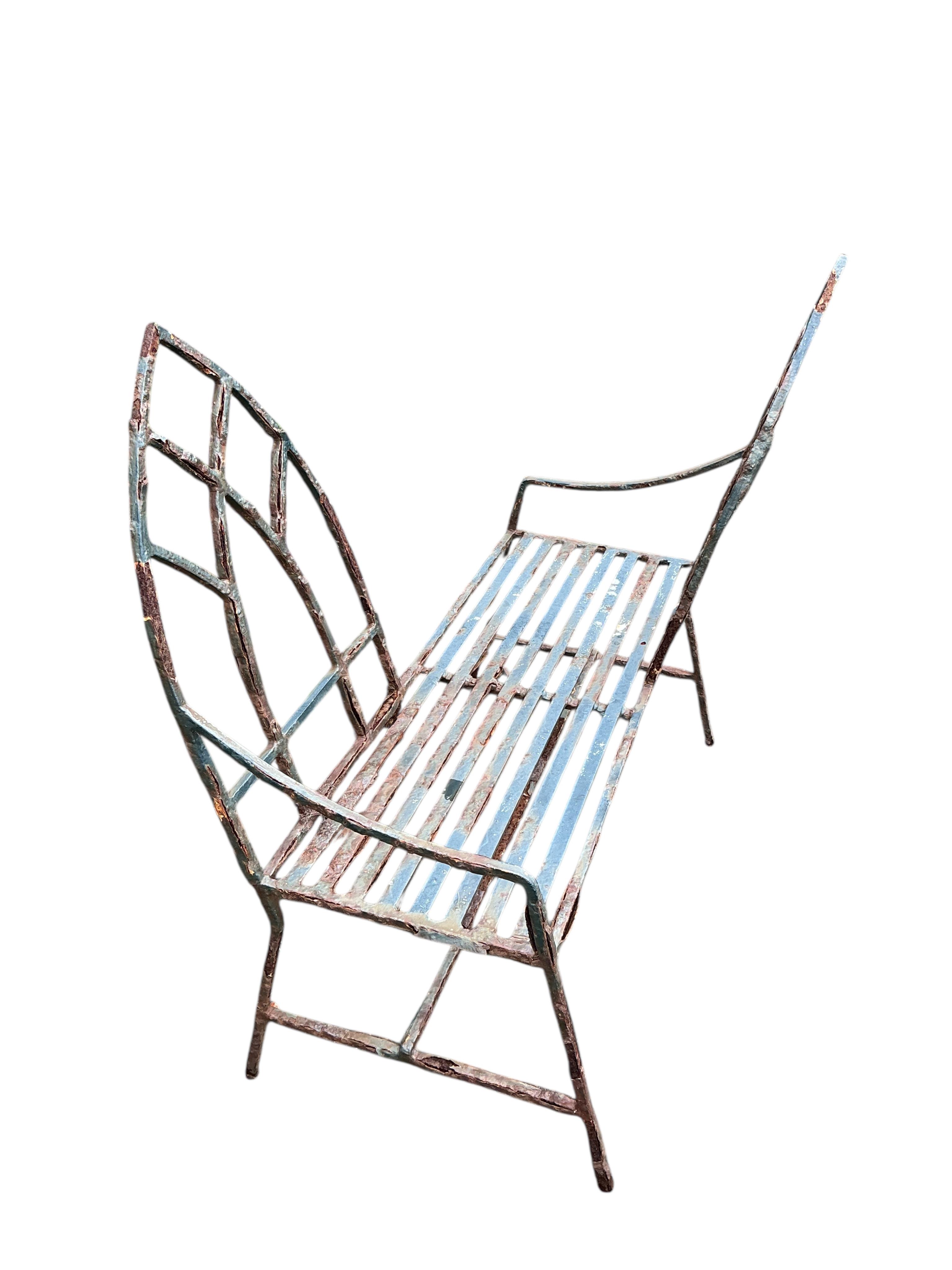 A Gothic style painted wrought iron garden love seat, width 94cm, height 98cm